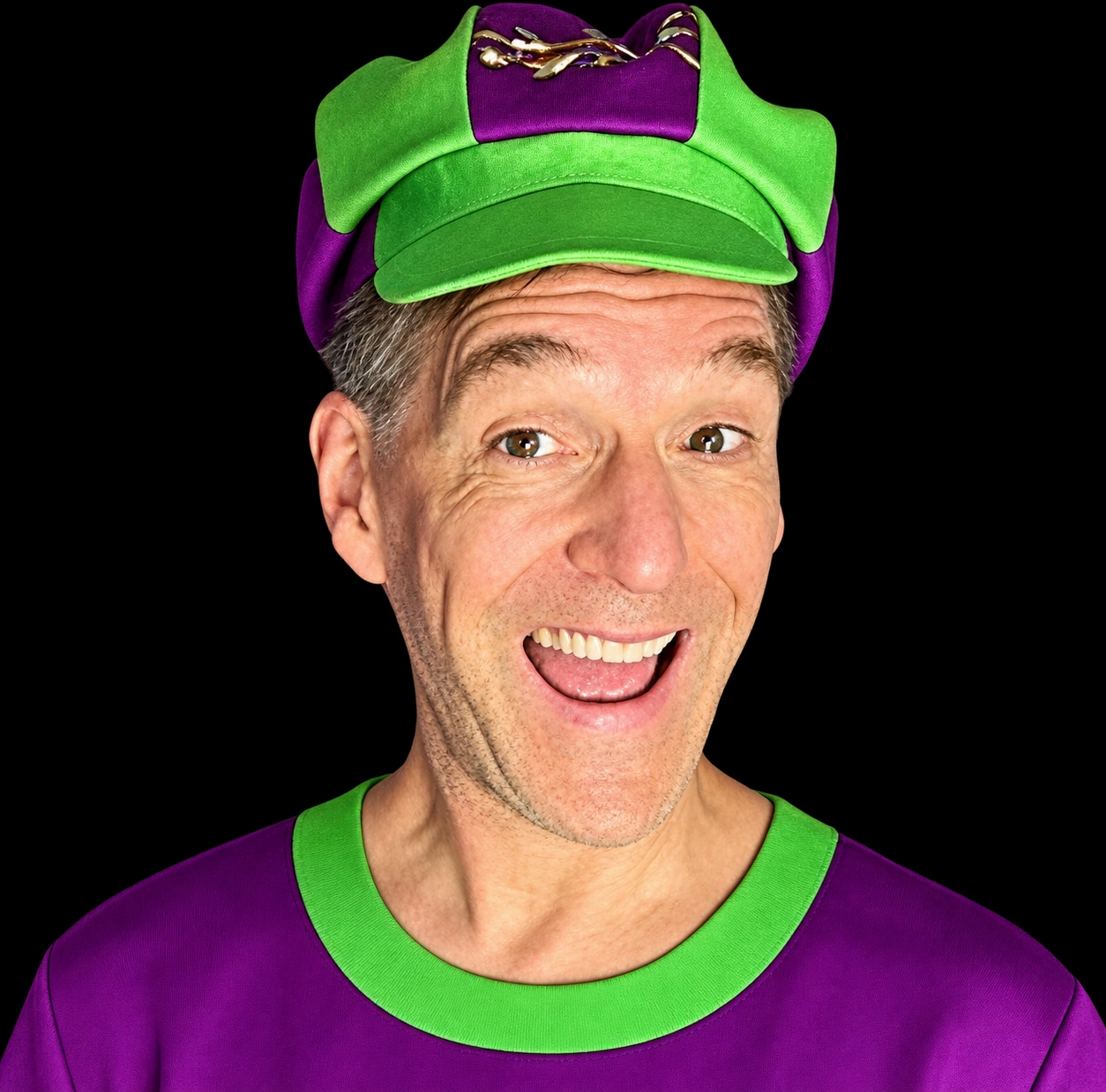 Todd Plaster smiling in his green and purple Master Plaster cap
